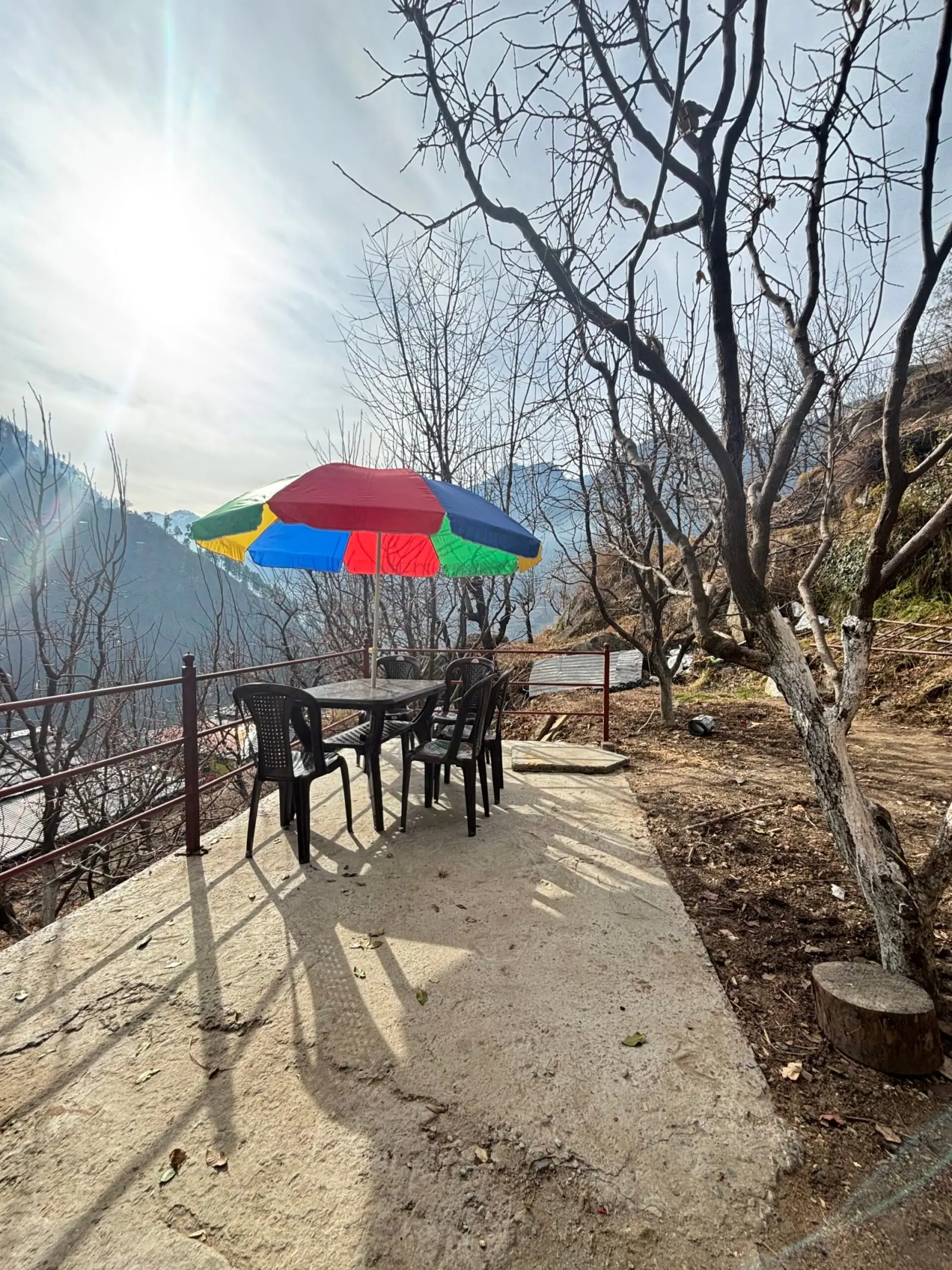 Terrace seating under a colourful umbrella at the retreat